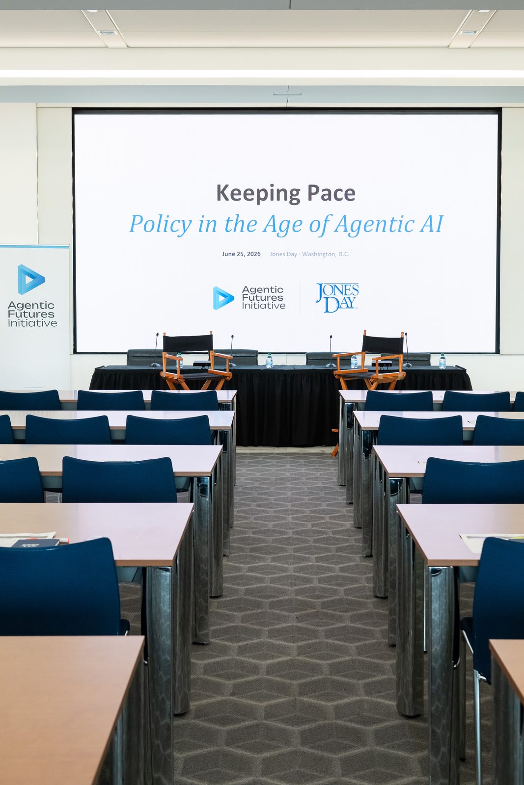 The symposium room before doors, title screen on display